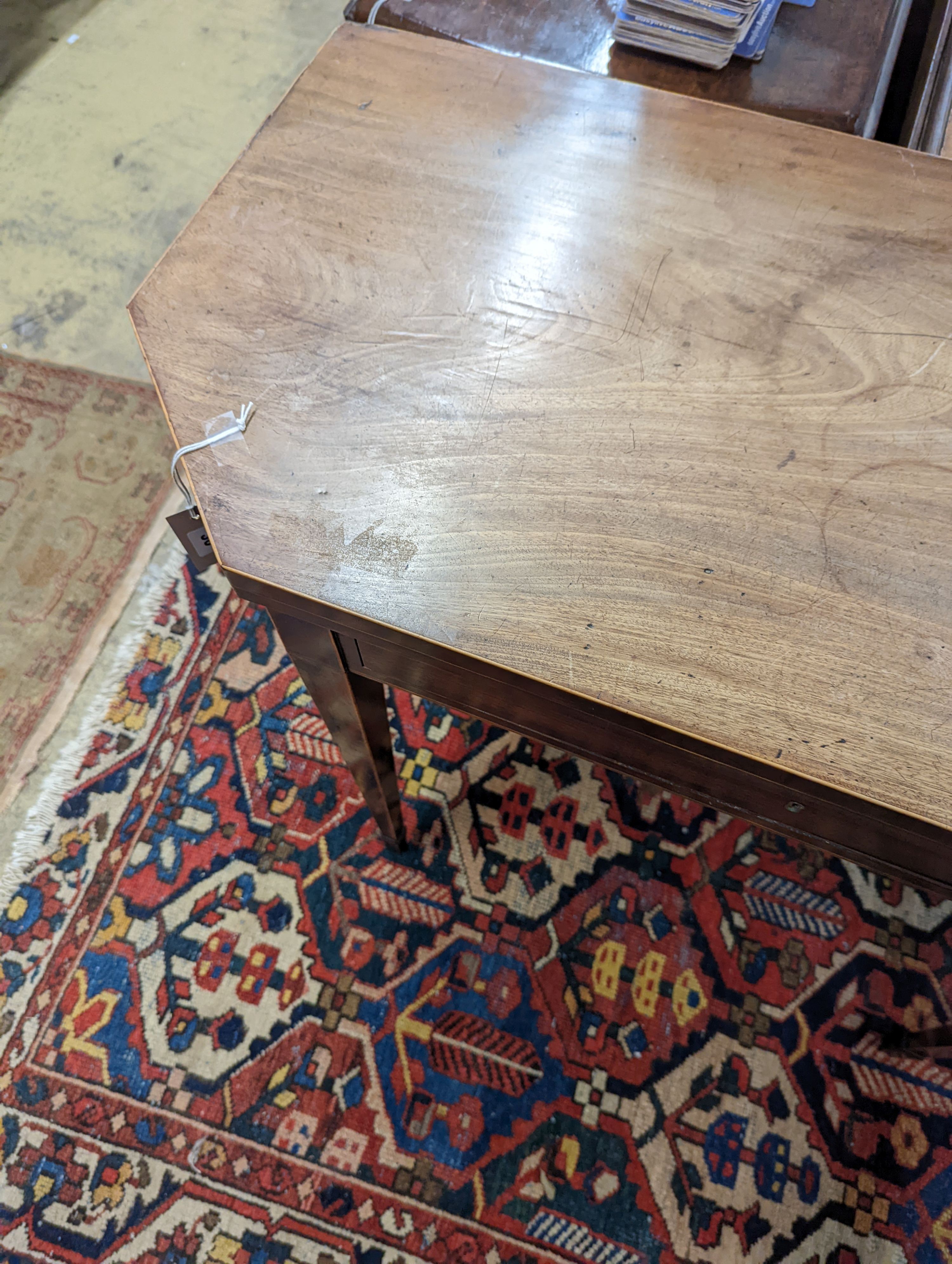 A George III faded mahogany folding tea table, width 97cm, depth 47cm, height 75cm